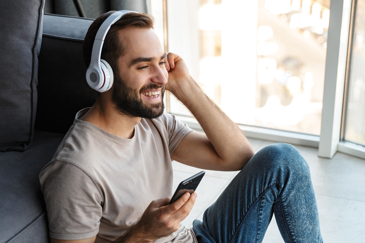 man-using-wireless-headphones-_-photo-shutterstock