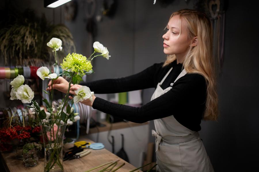 female-florist-making-beautiful-arrangement-flowers